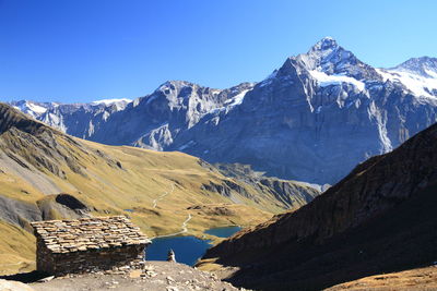 Scenic view of snowcapped mountains against clear sky