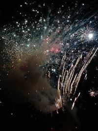 Low angle view of firework display at night