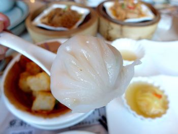 Close-up of shrimp dumpling on spoon at table