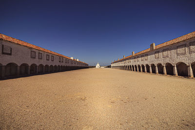 Surface level of historic building against clear blue sky