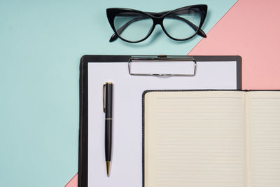 Directly above view of eyeglasses and clipboard