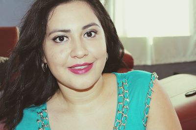 Close-up portrait of young woman at home