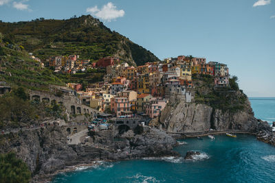 Scenic view of sea and buildings in town