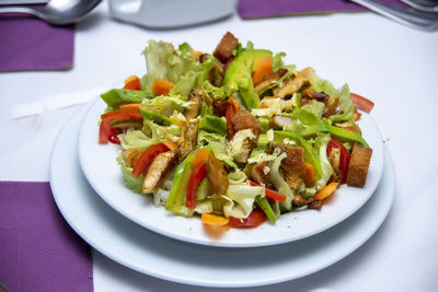 High angle view of chopped vegetables in plate on table