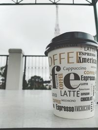 Close-up of coffee cup against sky