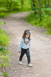 Full length of girl wearing mask on field