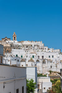 Low angle view of buildings against clear blue sky