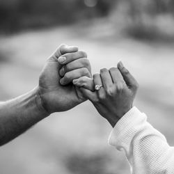 Cropped image of couple holding hands