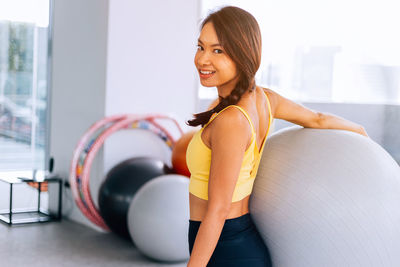 Young woman smiling while sitting at home