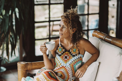 Young woman drinking coffee in cafe