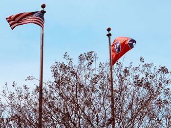 Low angle view of flags against clear sky