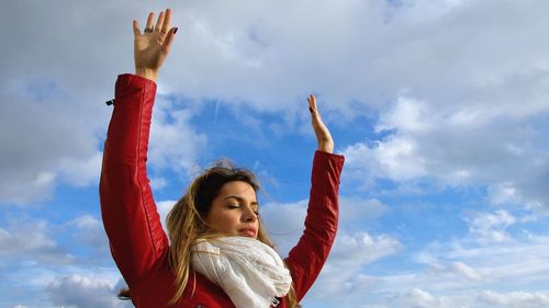 Low angle view of woman in traditional clothing against sky