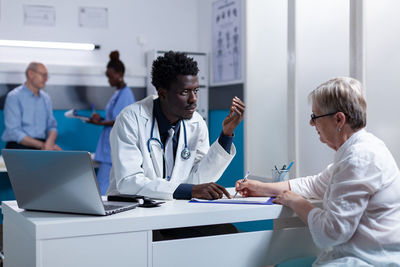 Doctor examining patient in clinic