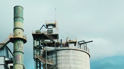 Low angle view of smoke stack against sky