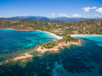 Scenic view of sea and mountains against sky