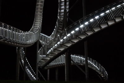 View of bridge over river at night