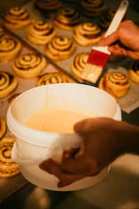 Cropped hand of woman holding coffee on table