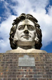 Low angle view of statue against sky