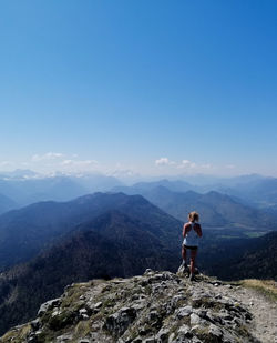 Women standing on mountain against sky