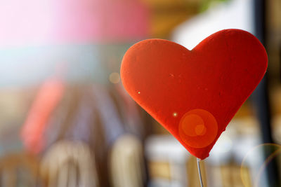 Close-up of heart shape decoration hanging on wood