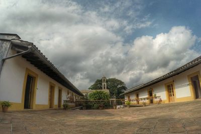 Buildings against cloudy sky