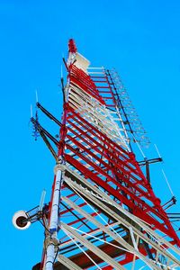 Low angle view of antenna tower against clear blue sky