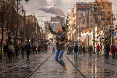 Woman jumping on city street