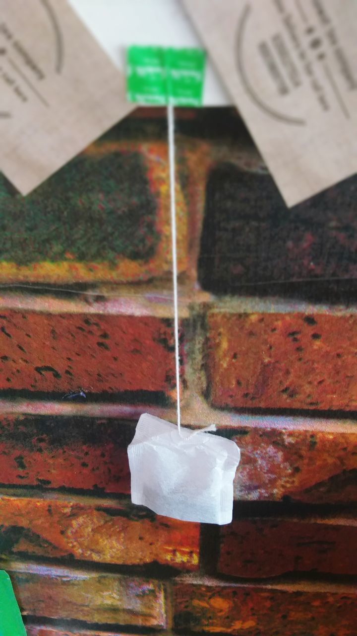 CLOSE-UP OF PAPER HANGING ON TABLE