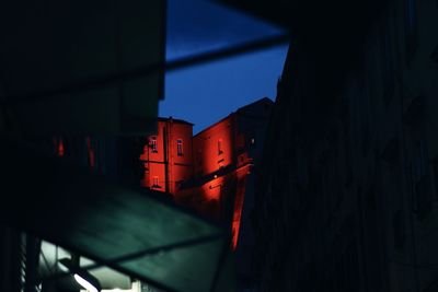 Low angle view of illuminated building against sky at night