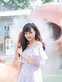 Portrait of happy woman standing outdoors