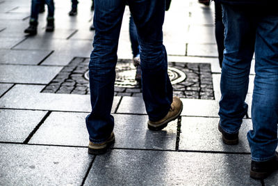 Low section of man standing on sidewalk