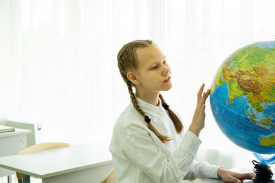 Cute girl touching globe