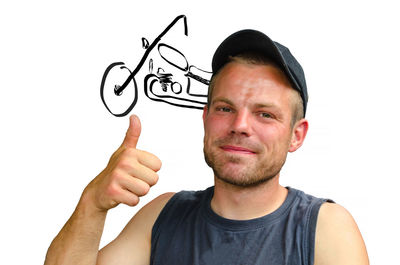 Portrait of young man standing against white background