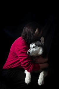 Close-up of dog against black background