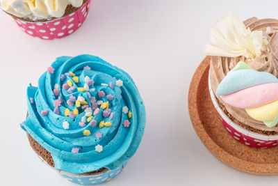 High angle view of cupcakes on table against white background