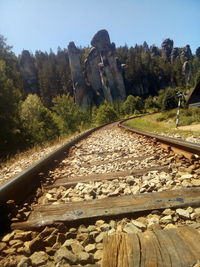 Railroad track amidst rocks against sky