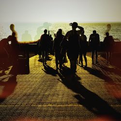 People on beach at sunset