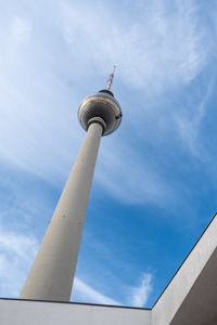 Low angle view of communications tower against sky