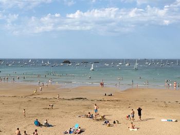 People on beach against sky