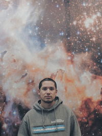 Portrait of man standing against sky