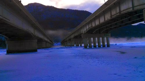 View of bridge over snow covered road