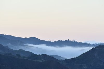 Scenic view of mountains against sky during sunset