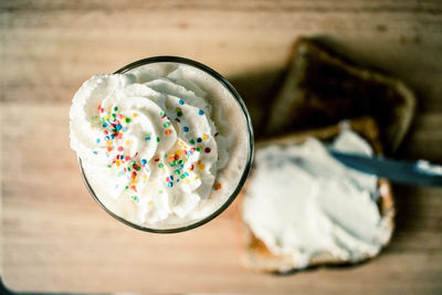 Close up of drink with whipped cream and sandwiches