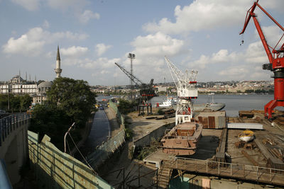 High angle view of cranes at commercial dock