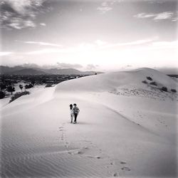 Man skiing on snowcapped mountain against sky