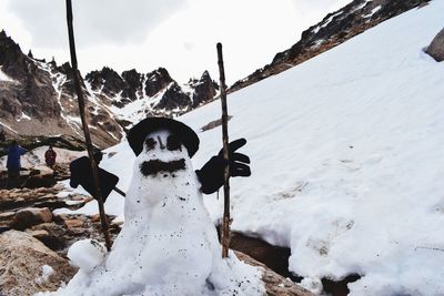 Snow covered field against sky