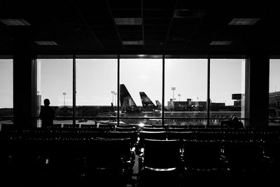 Airplane on airport runway against sky