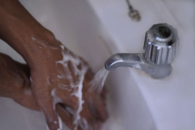 High angle view of hands in bathroom