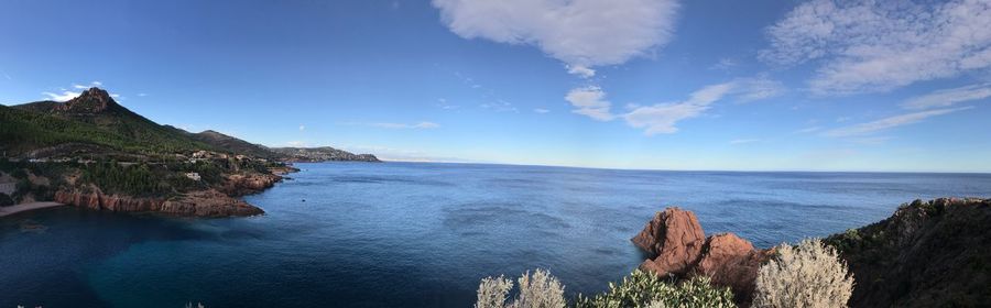 Panoramic view of sea against blue sky