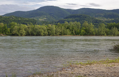 Scenic view of lake and mountains against sky